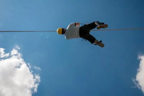 Firefighter training on wire, blue sky and clouds Stock Photos