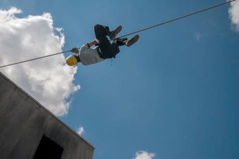 Firefighter training on wire, blue sky and clouds Stock Photos
