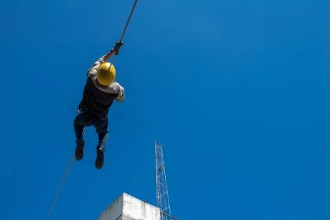 Firefighter training on wire, blue sky and clouds Stock Photos