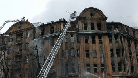 Firefighter on turntable ladder fighting fire Stock Footage 99437833