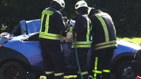 Firefighter using hydraulic cutter (jaws of life)  for vehicle extrication Stock Footage 30637364