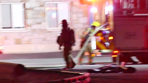 Firefighter walking during windy night Stock Footage 139655459