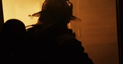 Firefighter walking into fire Stock Footage 91144543