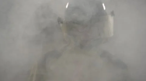 Firefighter walking towards camera through smoke, slow motion Stock Footage 10945334