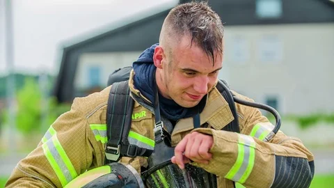 Firefighter is wiping his forehead because he is involved in a fast operation Stock Footage 108311585