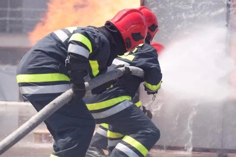 Firefighters in action. Firefighting. Stock Photos