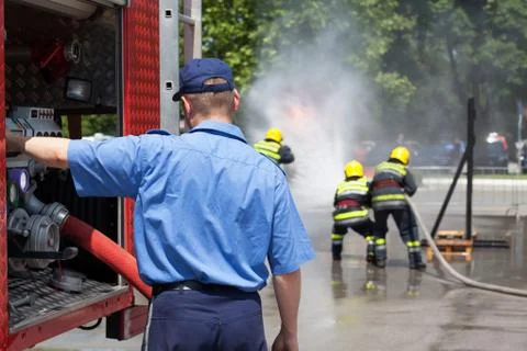Firefighters in action. Firefighting. Stock Photos