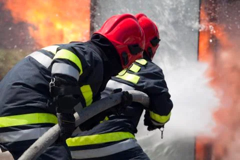 Firefighters in action Stock Photos