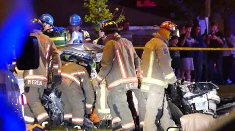 Firefighters and Paramedic Working on getting trapped person out of a car Video stock 57636606