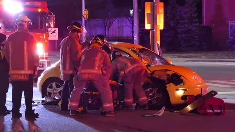 Firefighters And Paramedics Loading Patient Onto Stretcher After Extrication Video stock 76756595