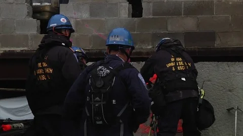 Firefighters and paramedics work on a simulated collapsed freeway or garage Stock Footage 74815268