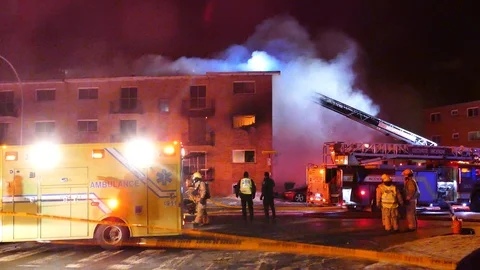 Firefighters and police officers analyzing structure fire situation Stock Footage 104299341
