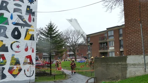 FIrefighters at apartment fire walking Stock Footage 139664323