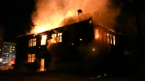 Firefighters are fighting a burning house fire. Stock Footage 295447124