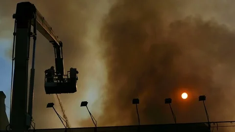 Firefighters are fighting with fire. Dense smoke rises over the building Stock Footage 76950654