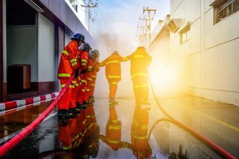 Firefighters are training firefighting methods for industrial workers Stock Photos