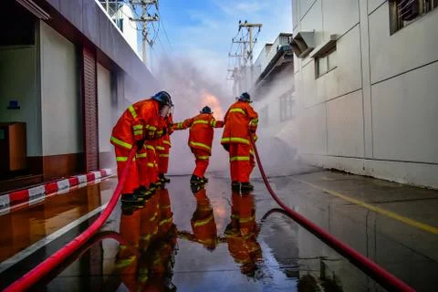 Firefighters are training firefighting methods for industrial workers Stock Photos