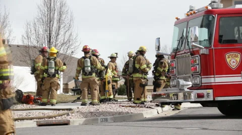 Firefighters around fire truck HD3907 Stock Footage