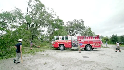 Firefighters arrive at the scene to remove fallen trees after Hurrican Irma Stock Footage 80339725