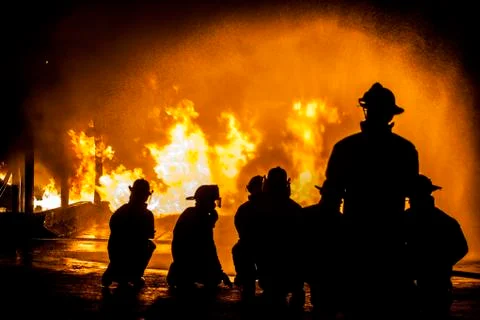 Firefighters assessing structural fire Stock Photos