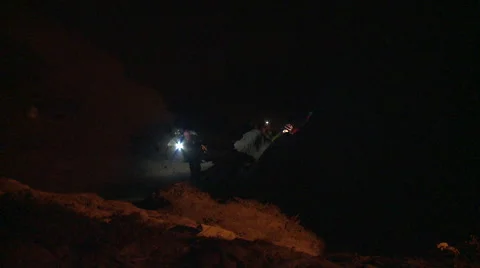 Firefighters attempt a night time Cliff Rescue using headlamps Video stock 40823795
