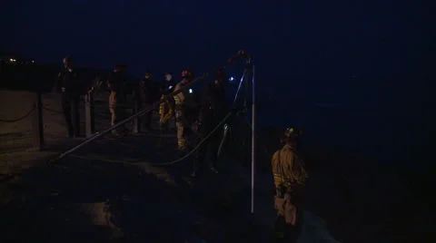 Firefighters attempt a night time Cliff Rescue Video stock 40825403