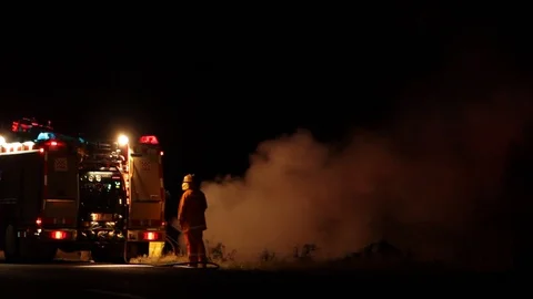 Firefighters attending a grass fire Stock Footage 91734614