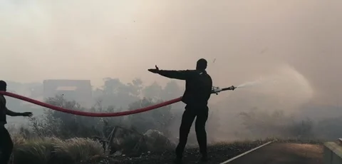 Firefighters battle a large wildfire on the slopes of Table Mountain, Cape Town Stock Footage 340228424