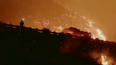 Firefighters battle the massive Thomas Fire in Ventura California along a major Stock Footage
