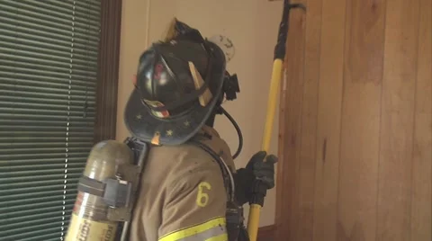 Firefighters breaking out ceiling and spraying water Video stock 924015