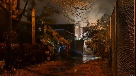 Firefighters at building fire at rainy night Stock Footage 120164056