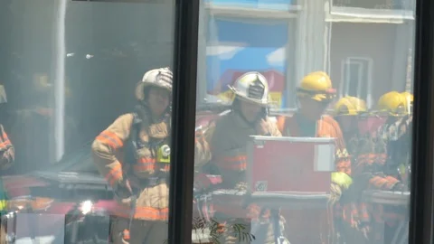 Firefighters command post in window reflection Stock Footage 114808052