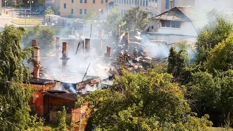 Firefighters continue to eliminate smoke on a object after an active burning Stock Footage 80019268