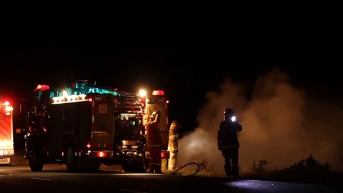 Firefighters Controlling a Grass Fire Stock Footage 91734582