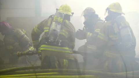 Firefighters crawl toward flames Stock Footage 60761736