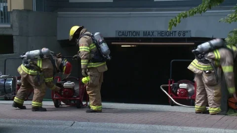 Firefighters dealing with equipment on scene. 스톡 동영상 76757998