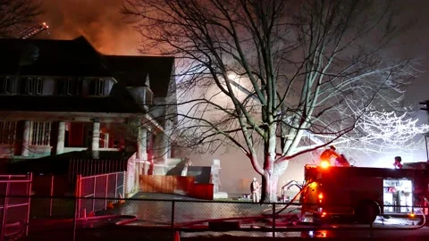 Firefighters dealing with old building fire Stock Footage 139657402