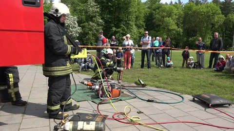 Firefighters demonstrate various tool used rescue operations. 4K Stock Footage 56993110