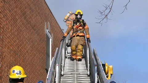 Firefighters descending ladder Stock Footage 101996140