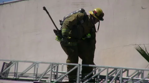 Firefighters descends a ladder Stock Footage 5165770