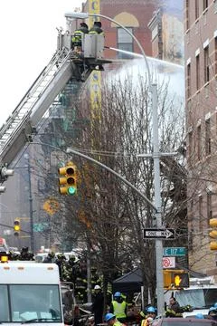  Firefighters dig through the rubble of an explosion on 116 St and Park Av... Fotos de archivo