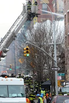  Firefighters dig through the rubble of an explosion on 116 St and Park Av... Fotos de archivo