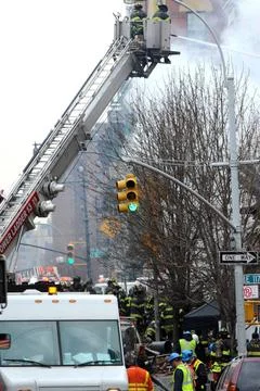  Firefighters dig through the rubble of an explosion on 116 St and Park Av... Fotos de archivo