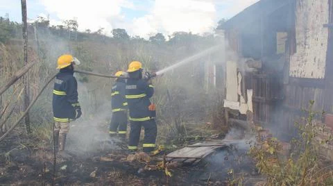 Firefighters during fire fighting Stock Photos