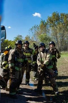 Firefighters engage in training at the academy while wearing protective gea.. Stock-Fotos
