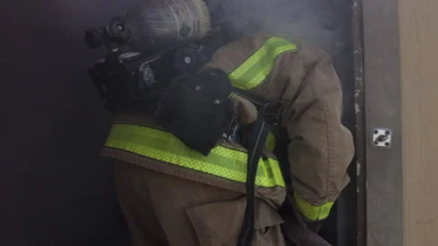 Firefighters enter building on fire in slow-motion Stock Footage 133595097