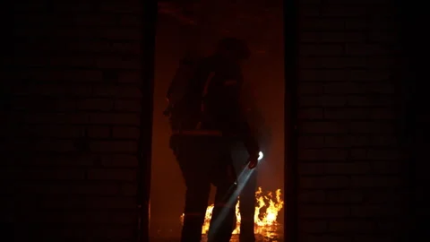 Firefighters with equipment inside a burning house looking for survivors Stock Footage 283170955