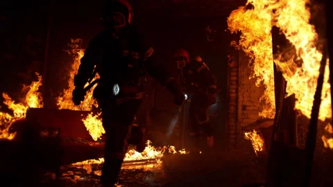Firefighters with equipment inside a burning house Stock Footage 283172057