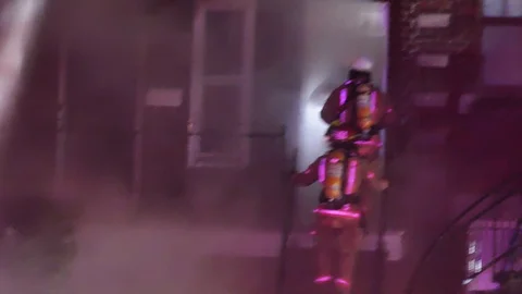 Firefighters escalading stairs of a building on fire Stock Footage 115929461