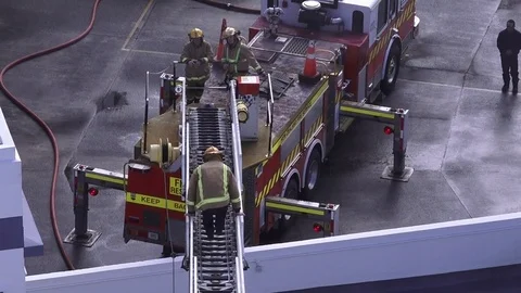 Firefighters exercise maneuvering fire engine ladder 03 Video stock 78953023